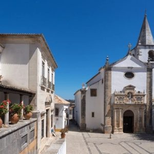 Obidos town entrance gate with historic architecture and tourists