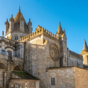 Romanesque-Gothic cathedral with detailed stone façade and twin towers