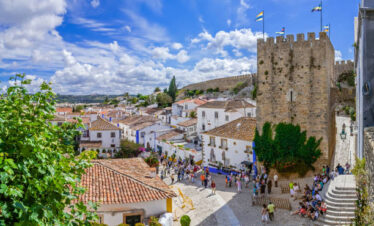 Historic walled town of Obidos, near Lisbon, Portugal. Beautiful streets of Obidos Medieval Town, Portugal. Street view of medieval fortress in Castelo de Obidos. Portugal.